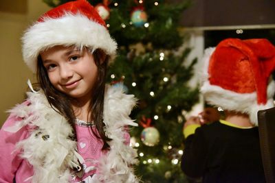 Portrait of happy girl with christmas tree