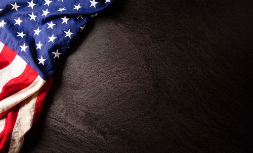 Low angle view of flag against black background