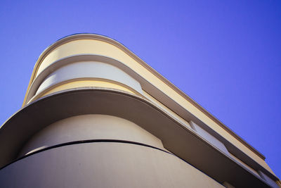 Low angle view of modern building against blue sky
