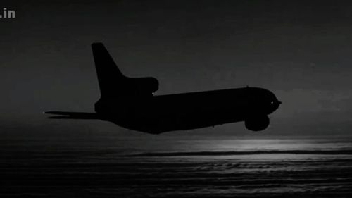 Silhouette of airplane at sea