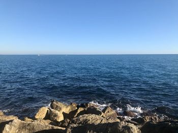 Scenic view of sea against clear blue sky