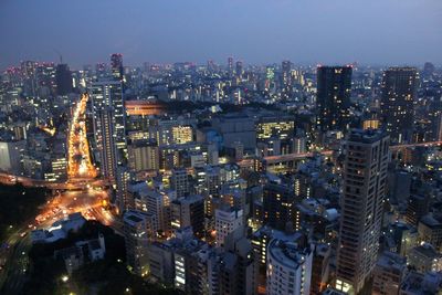 High angle view of city lit up at night