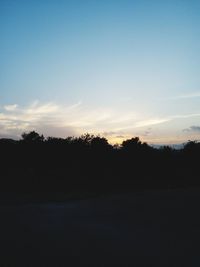 Scenic view of silhouette trees against sky during sunset