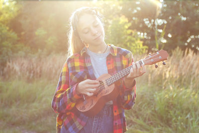 Young woman playing guitar