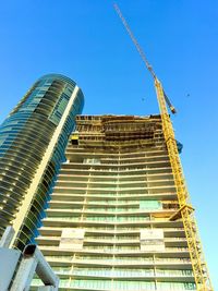 Low angle view of modern building against blue sky