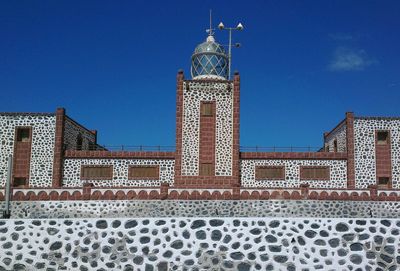 Low angle view of buildings against blue sky