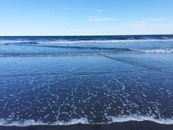 Close-up of sea against blue sky