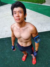 Portrait of young man standing in park