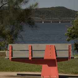 Bridge over river against trees