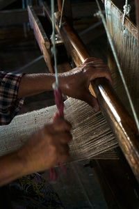 Midsection of person working in factory