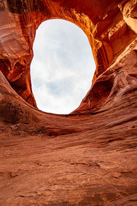 View of rock formation against cloudy sky