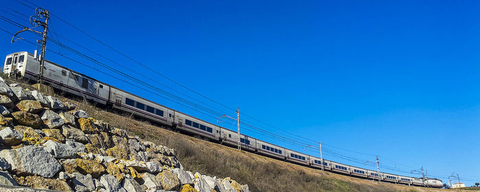 Low angle view of bridge against blue sky