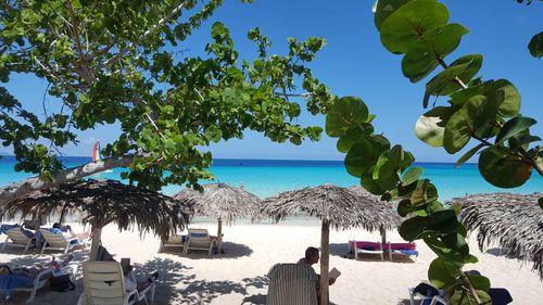 Scenic view of beach against blue sky