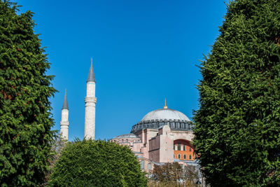 View of trees and building against sky