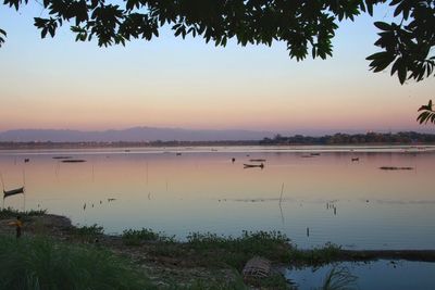 Scenic view of lake against sky during sunset