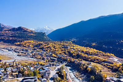 High angle view of townscape and mountains against sky