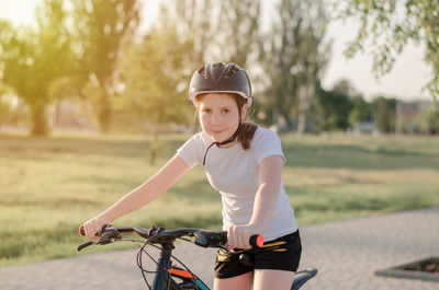 Boy riding bicycle on field