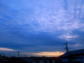 Low angle view of silhouette buildings against dramatic sky