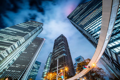 Low angle view of illuminated buildings against sky at dusk