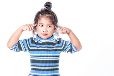 Portrait of cute girl against white background