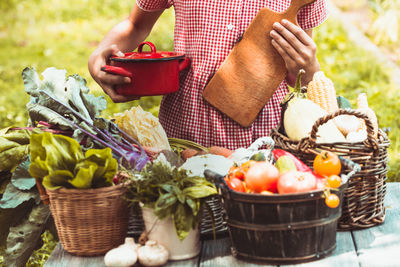 Midsection of man with ice cream in basket