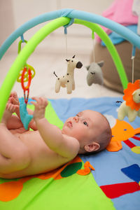 Cute baby girl lying on toy toys