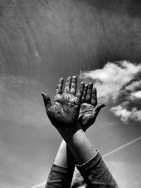 Cropped image of dirty hands against sky