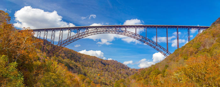 Arch bridge against sky during autumn