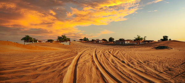 Scenic view of beach against sky during sunset