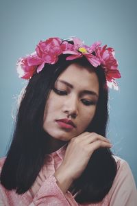 Portrait of beautiful woman with pink flower