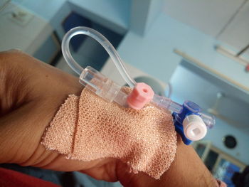 Close-up of hand with iv drip in hospital