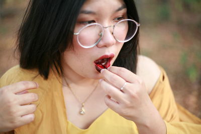 Close-up portrait of woman eating ice cream