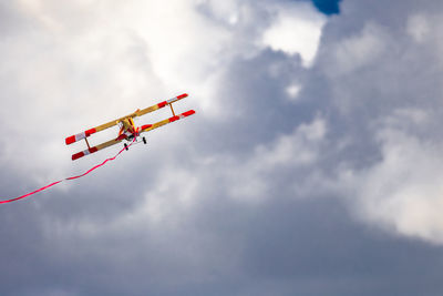 Low angle view of airplane flying against sky