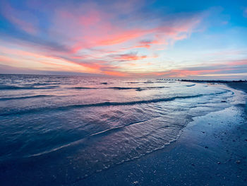 Scenic view of beach against sky during sunset