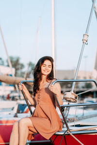 Portrait of smiling woman sitting on boat