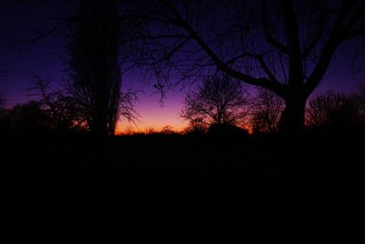 Silhouette trees against sky at sunset