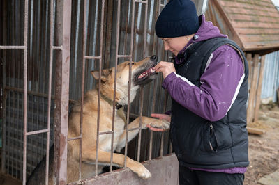 Girl volunteer in the nursery for dogs. shelter for stray dogs.