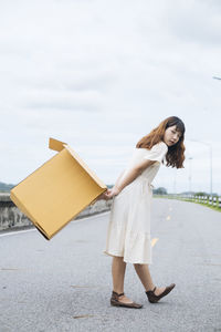 Full length of woman standing against sky