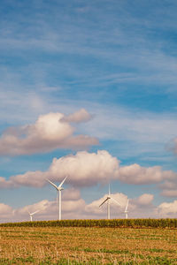 Windmill on field against sky