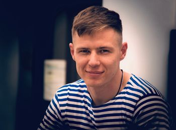 Portrait of smiling young man sitting outdoors