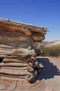 Stack of wood against clear sky
