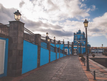 Street amidst buildings against sky