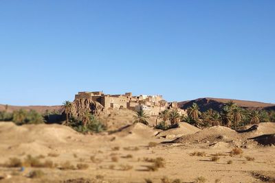 Old ruins in desert against clear blue sky