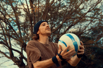 Portrait of young man with a soccer ball