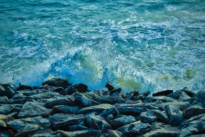 Waves splashing on rocks at shore