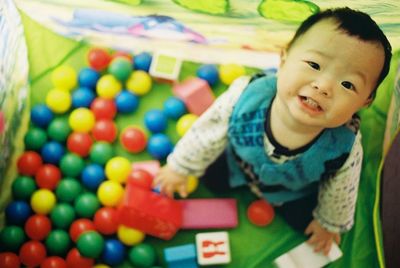 Portrait of baby boy in colorful ball pool