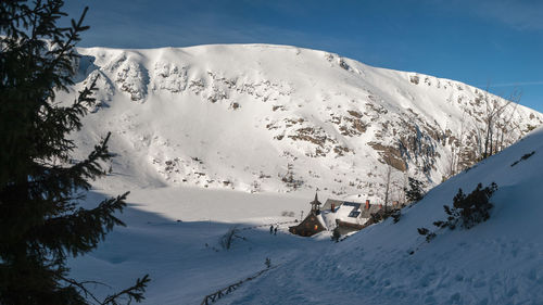 Scenic view of snow covered mountains against sky