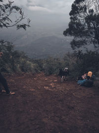 People walking on land against sky