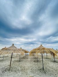 Straw beach umbrellas on a blue sky and sea background.copy space