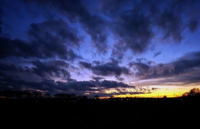 Scenic view of silhouette landscape against dramatic sky